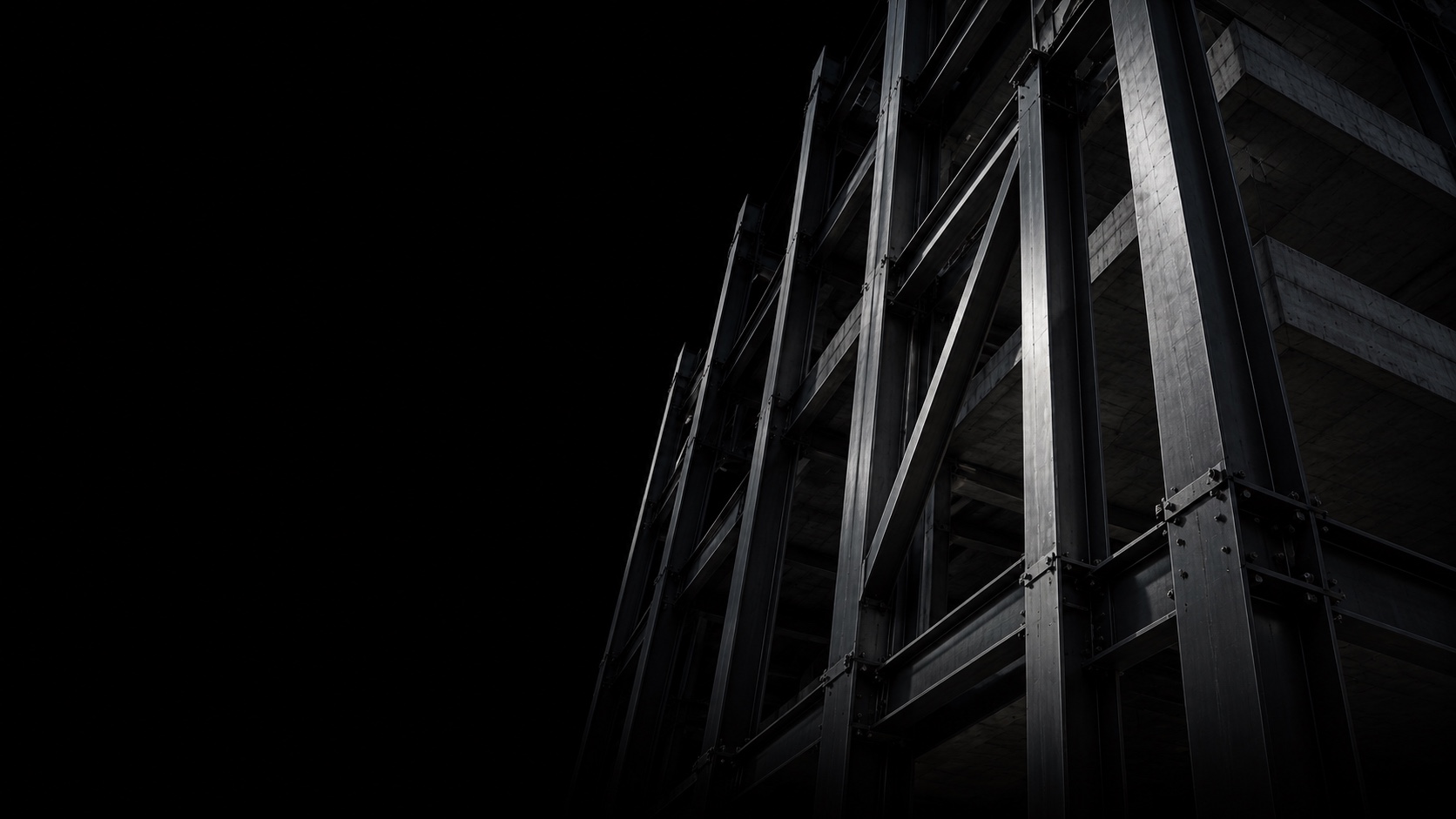 Steel framing and concrete floors emerging from a black background